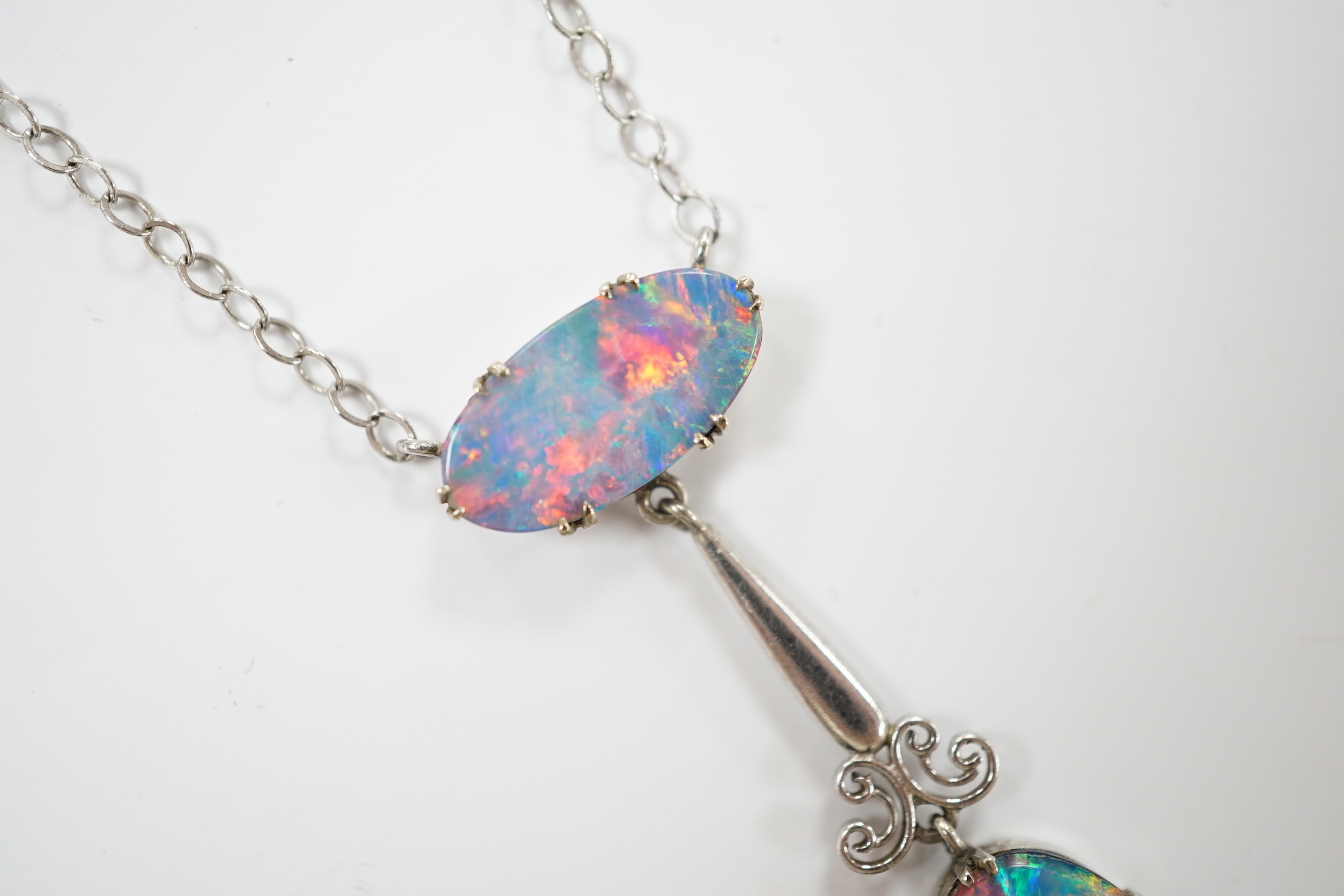 A 1920's style 9ct white metal and two stone black opal doublet set drop pendant necklace, overall 58cm, gross weight 4 grams.
